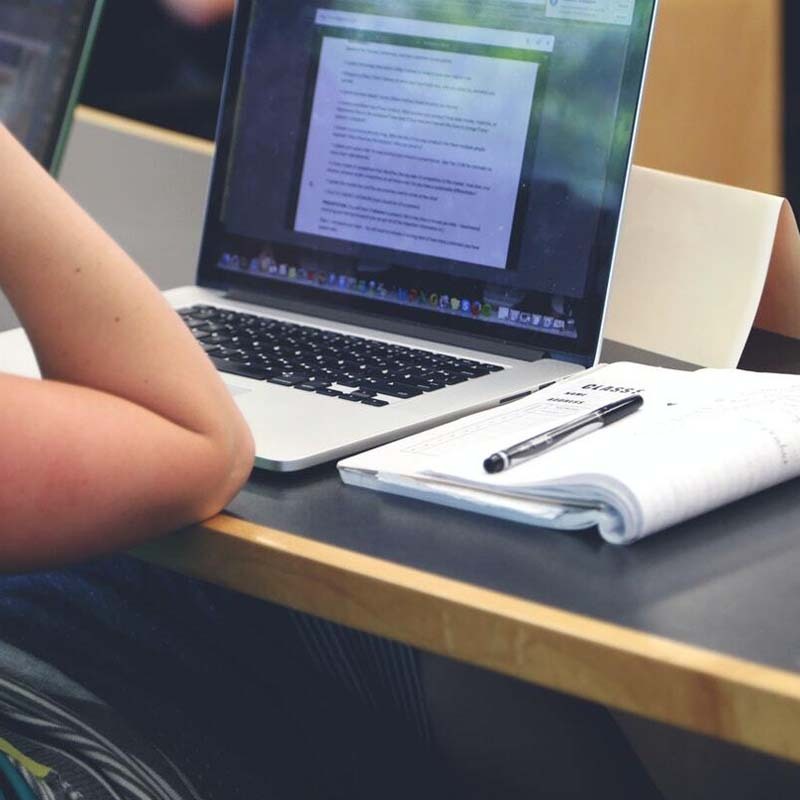 students with computer - clever ways students cheat in online exams - digify